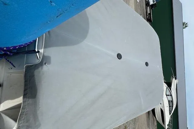 Slide: The Image of Covered 1995 Regal 256 Commodore boat docked at a marina. - 5