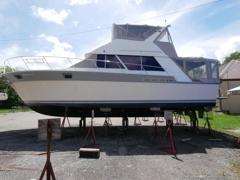 Slide: The Image of 1986 Silverton 40 Convertible boat on stands in a yard. - 10