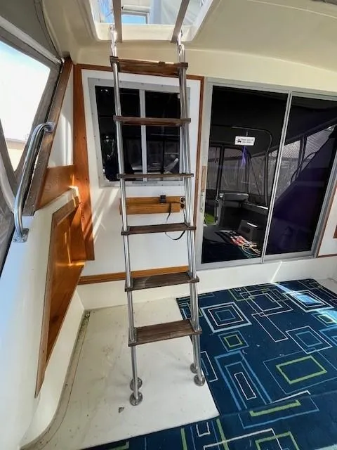 Slide: The Image of Interior of a 1986 Silverton 40 Convertible boat with ladder and modern decor. - 13