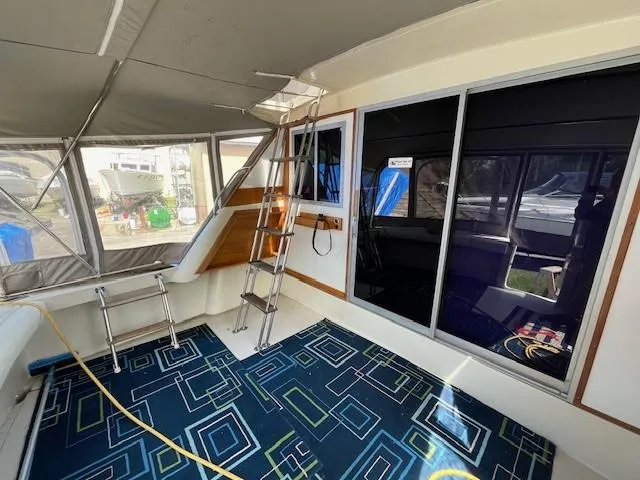 Slide: The Image of 1986 Silverton 40 Convertible interior with modern decor and ladder access. - 15