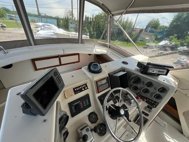 Slide: The Image of 1986 Silverton 40 Convertible boat helm with navigation equipment and steering wheel. - 18