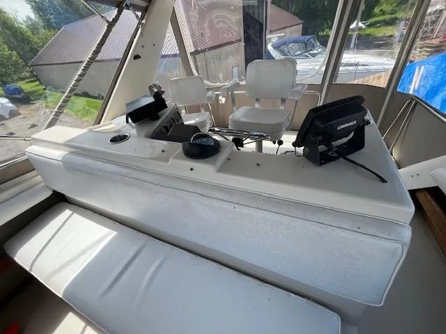 Slide: The Image of 1986 Silverton 40 Convertible boat cockpit with seating and navigation equipment. - 19