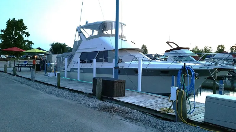 Slide: The Image of 1986 Silverton 40 Convertible yacht docked at a marina. - 2