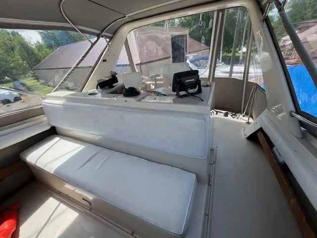 Slide: The Image of Interior of 1986 Silverton 40 Convertible boat with white seating and navigation equipment. - 20