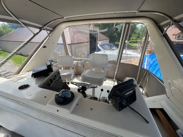 Slide: The Image of 1986 Silverton 40 Convertible boat cockpit with helm, controls, and seating. - 21