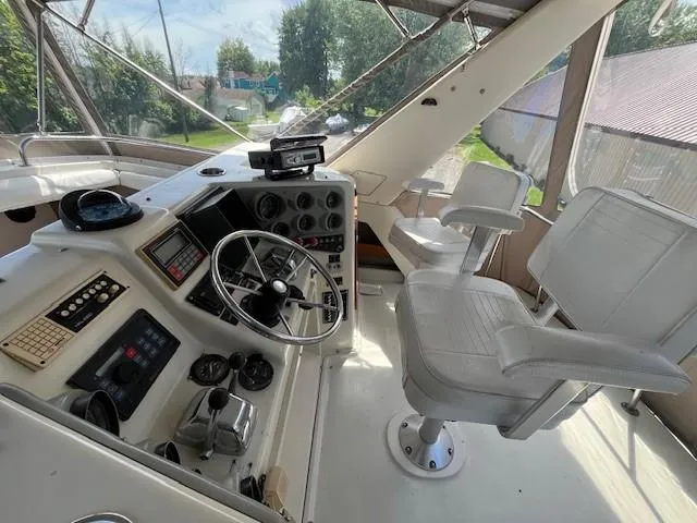 Slide: The Image of 1986 Silverton 40 Convertible boat helm with steering wheel and captain's chair. - 22