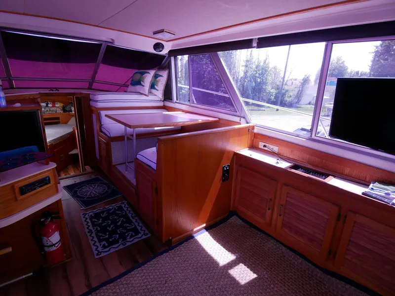Slide: The Image of Interior of 1986 Silverton 40 Convertible yacht with wood furnishings and large windows. - 26
