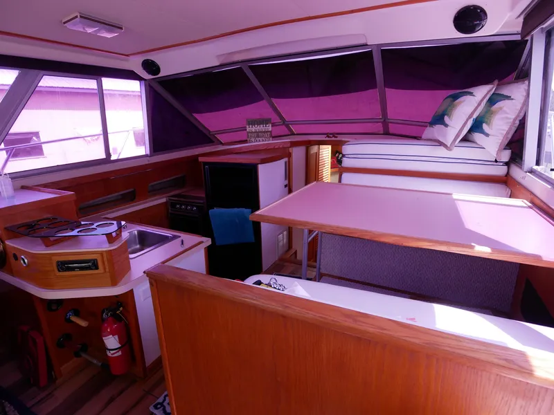 Slide: The Image of Interior of 1986 Silverton 40 Convertible boat with kitchen and seating area. - 27
