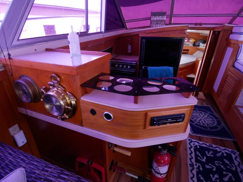 Slide: The Image of 1986 Silverton 40 Convertible yacht interior with kitchen and navigation instruments. - 28