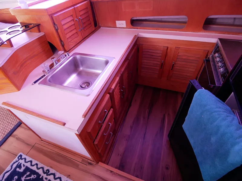 Slide: The Image of 1986 Silverton 40 Convertible kitchen with sink, stove, and wooden cabinets. - 29