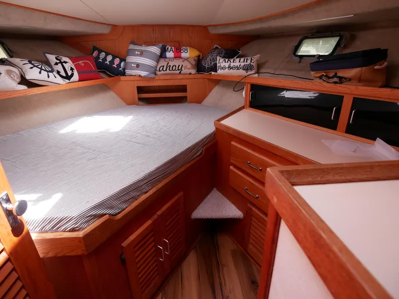 Slide: The Image of Cozy cabin interior of a 1986 Silverton 40 Convertible boat with nautical-themed decor. - 36