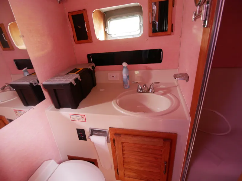 Slide: The Image of 1986 Silverton 40 Convertible bathroom with sink, mirror, and storage cabinets. - 37