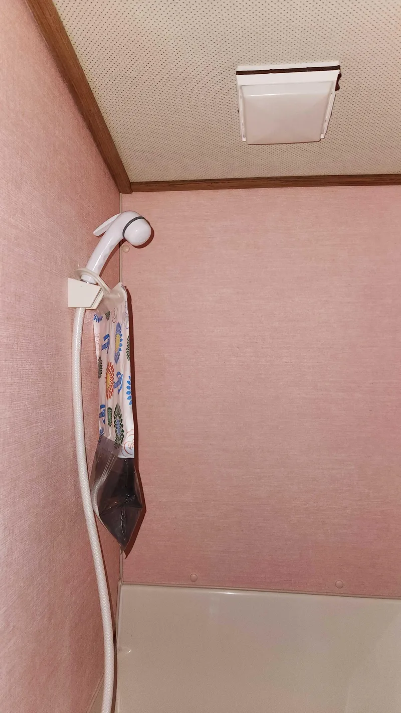 Slide: The Image of 1986 Silverton 40 Convertible bathroom with pink walls and showerhead. - 40