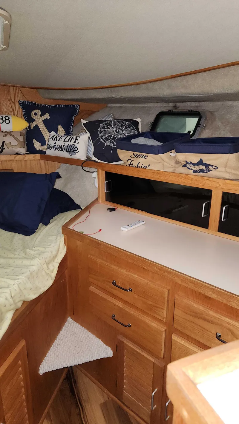 Slide: The Image of 1986 Silverton 40 Convertible cabin interior with nautical-themed decor and wooden cabinetry. - 41