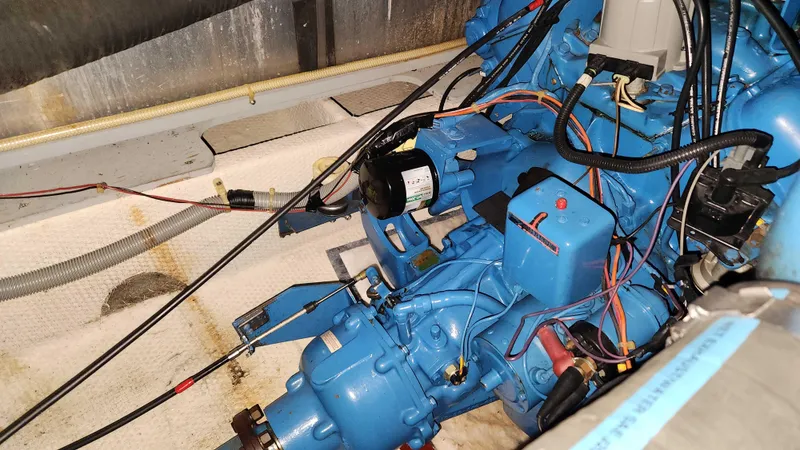 Slide: The Image of Engine compartment of a 1986 Silverton 40 Convertible boat with blue engine. - 42