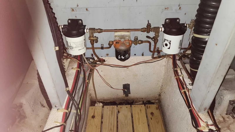 Slide: The Image of Engine compartment of a 1986 Silverton 40 Convertible boat showing fuel filters and wiring. - 44