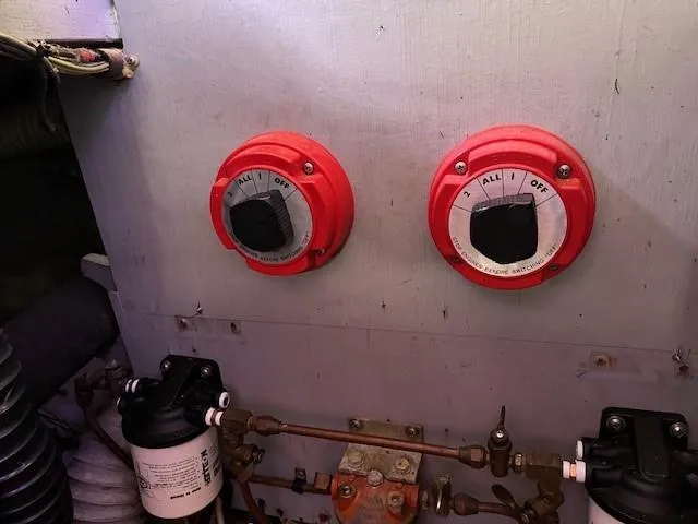 Slide: The Image of 1986 Silverton 40 Convertible boat engine room with red control switches. - 46