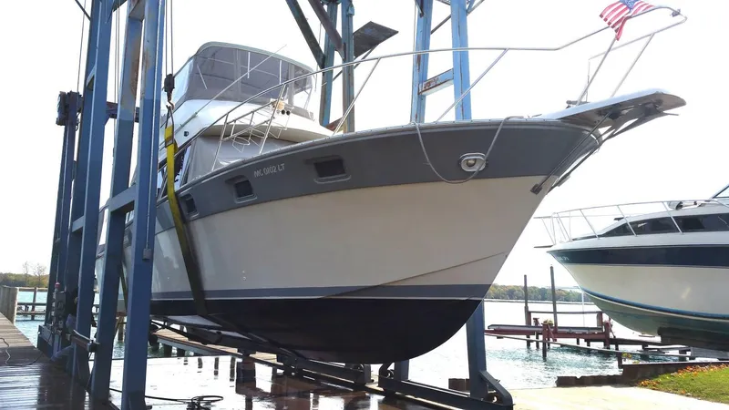 Slide: The Image of 1986 Silverton 40 Convertible boat on a lift at a marina. - 49