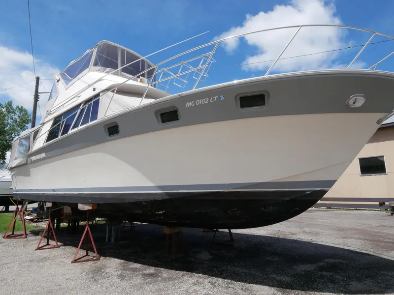 Slide: The Image of 1986 Silverton 40 Convertible boat on stands for maintenance. - 7