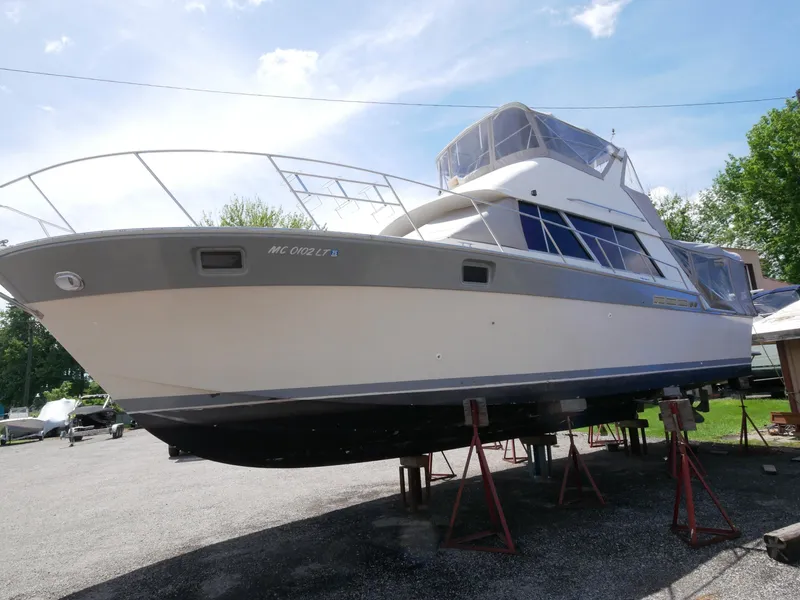 Slide: The Image of 1986 Silverton 40 Convertible boat on stands in a yard. - 9