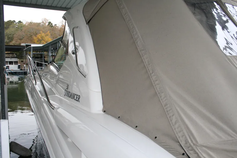 Slide: The Image of 2006 Sea Ray Sundancer 380 docked under a covered marina. - 11