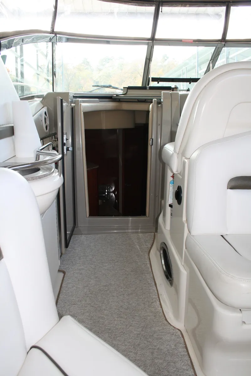 Slide: The Image of 2006 Sea Ray Sundancer 380 interior with white seating and cabin entrance. - 12