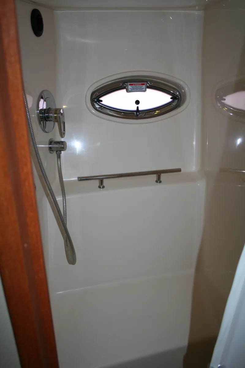 Slide: The Image of Shower area in 2006 Sea Ray Sundancer 380 yacht with oval window and chrome fixtures. - 13