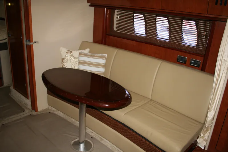 Slide: The Image of Interior of 2006 Sea Ray Sundancer 380 with beige seating and wooden table. - 17