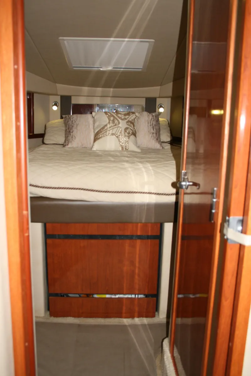 Slide: The Image of Interior cabin of 2006 Sea Ray Sundancer 380 with cozy bed and elegant wood finish. - 21