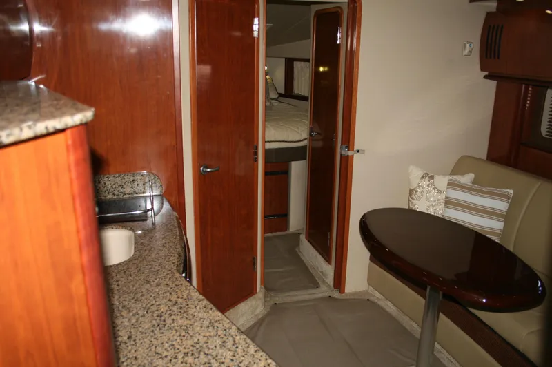 Slide: The Image of Interior of 2006 Sea Ray Sundancer 380 yacht with kitchenette and seating area. - 24