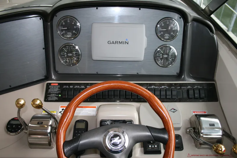 Slide: The Image of 2006 Sea Ray Sundancer 380 helm with Garmin navigation and classic wood steering wheel. - 30