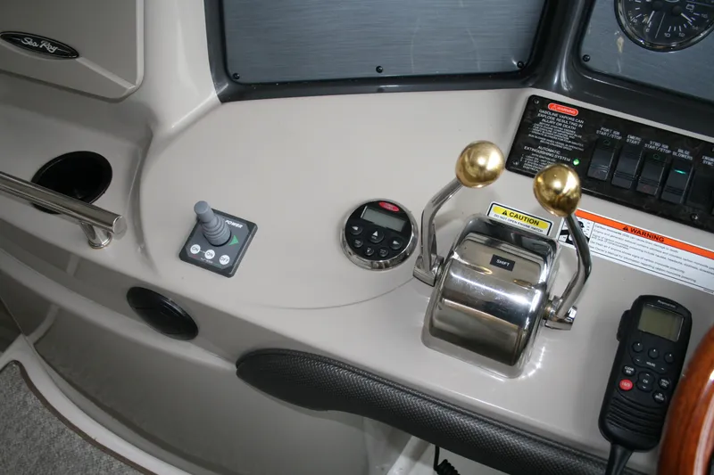 Slide: The Image of Control panel of a 2006 Sea Ray Sundancer 380 boat with throttle and joystick. - 8