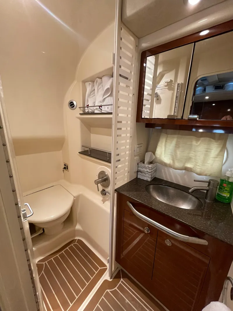 Slide: The Image of 2014 Sea Ray 370 Sundancer bathroom with sink, mirror, and toilet. - 12