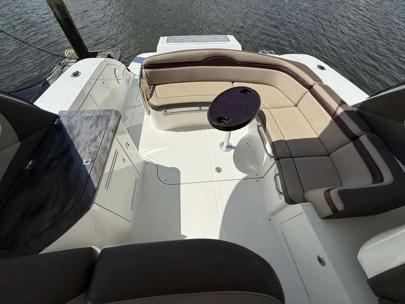 Slide: The Image of 2014 Sea Ray 370 Sundancer boat with spacious seating and table on deck. - 17
