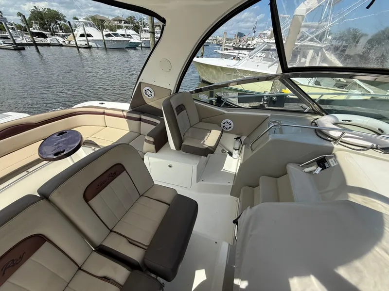 Slide: The Image of 2014 Sea Ray 370 Sundancer interior with seating, docked at marina. - 19