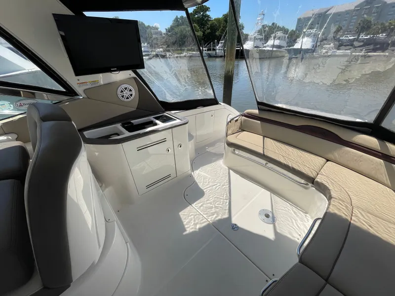 Slide: The Image of Interior of 2014 Sea Ray 370 Sundancer yacht with seating, TV, and waterfront view. - 21