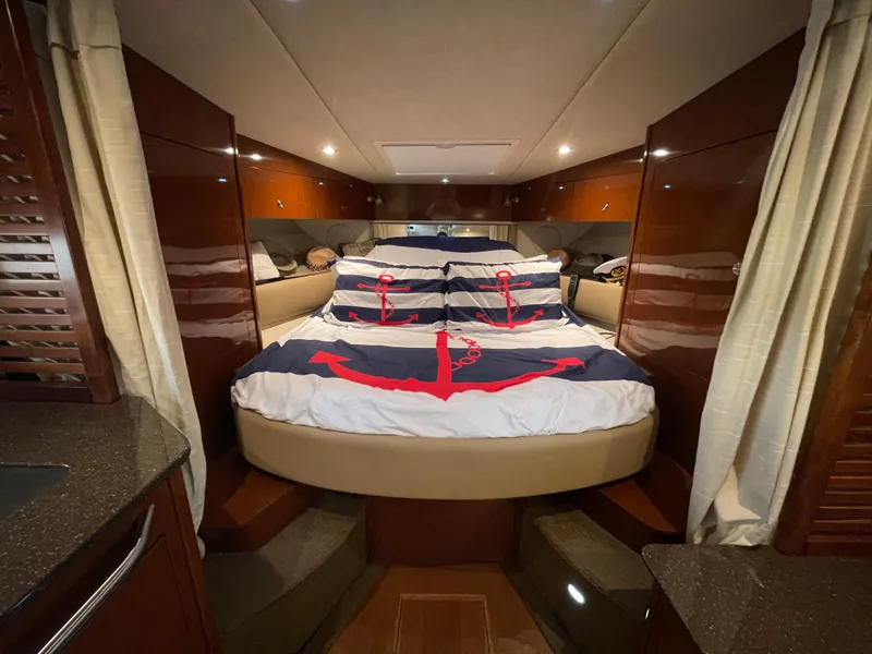 Slide: The Image of Luxurious cabin interior of a 2014 Sea Ray 370 Sundancer yacht with anchor-themed bedding. - 5