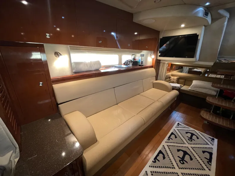 Slide: The Image of Interior of 2014 Sea Ray 370 Sundancer with beige leather sofa and modern amenities. - 6