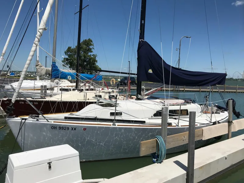 Slide: The Image of 1980 Chrysler S-27 sailboat docked at marina under clear blue sky. - 11