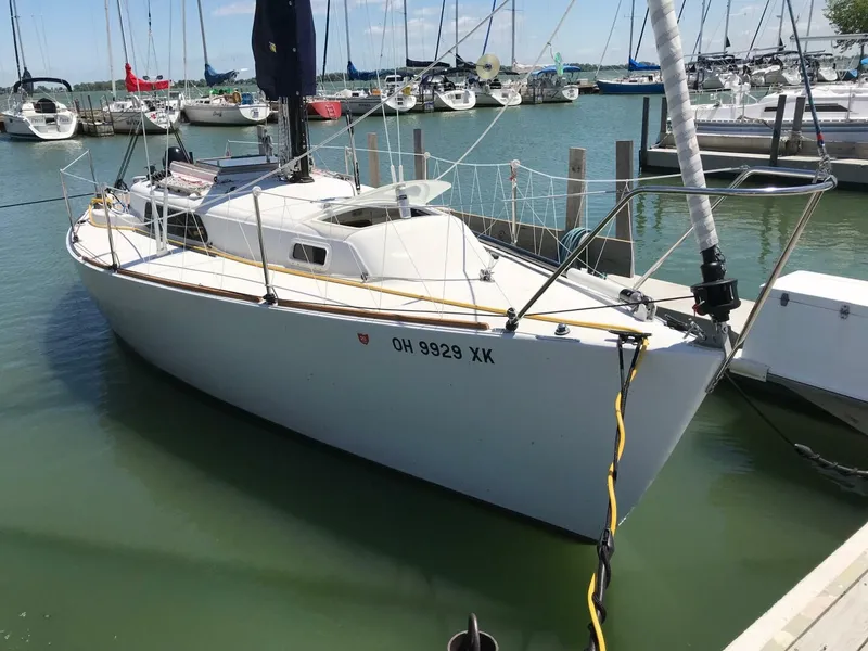 Slide: The Image of 1980 Chrysler S-27 sailboat docked in marina, surrounded by other boats. - 12