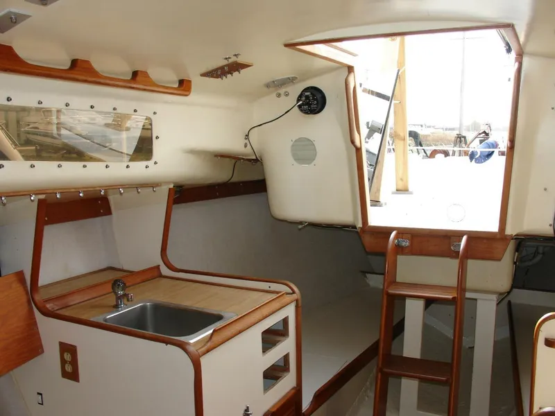 Slide: The Image of Interior of 1980 Chrysler S-27 sailboat with kitchenette and wooden ladder. - 17