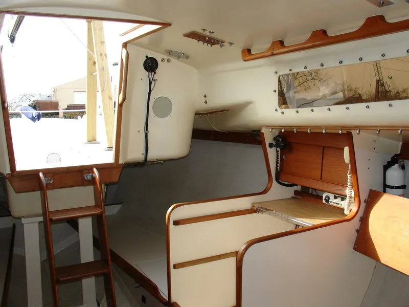 Slide: The Image of Interior of 1980 Chrysler S-27 sailboat with wooden accents and compact cabin layout. - 19