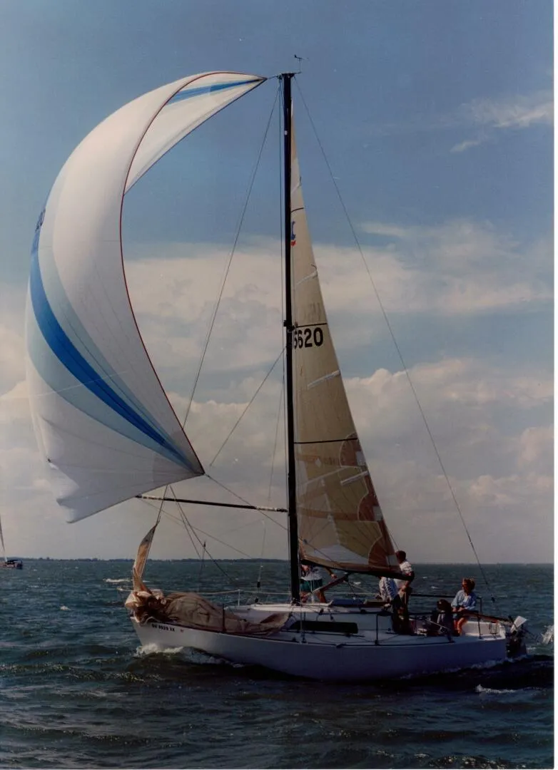 Slide: The Image of 1980 Chrysler S-27 sailboat with spinnaker on open water. - 3