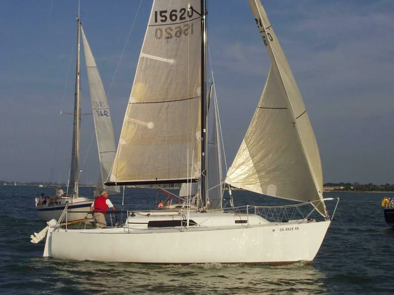 Slide: The Image of 1980 Chrysler S-27 sailboat on open water with sails unfurled. - 4