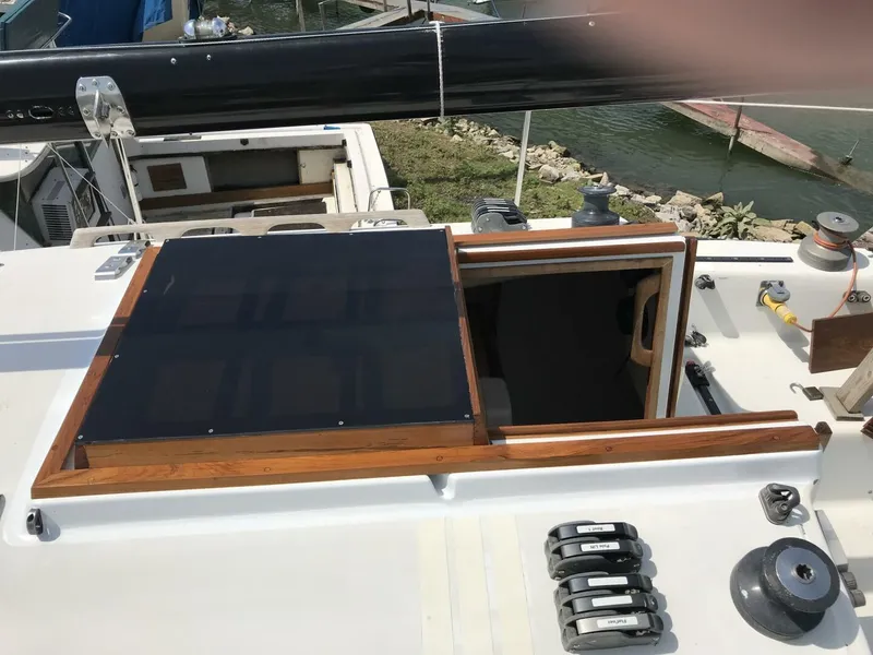 Slide: The Image of 1980 Chrysler S-27 yacht deck with solar panel and open hatch. - 9