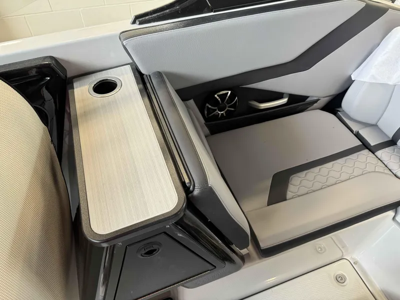 Slide: The Image of 2024 Yamaha Boats 255XE interior seating with cup holder and speaker. - 11