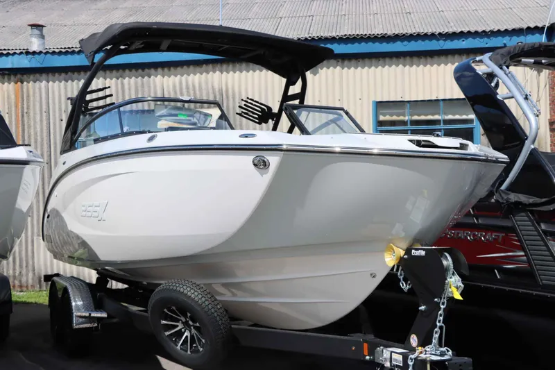 Slide: The Image of 2024 Yamaha Boats 255XE on trailer, sleek design, parked outdoors. - 12