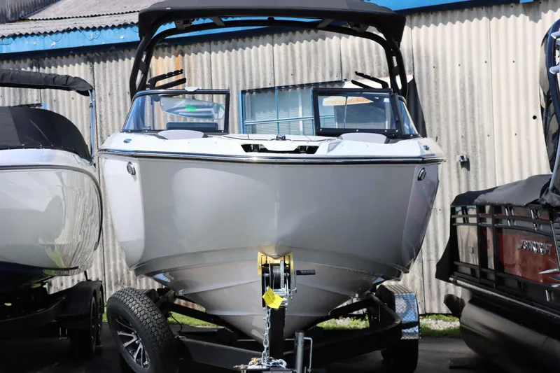 Slide: The Image of 2024 Yamaha Boats 255XE on trailer, displayed outdoors. - 13