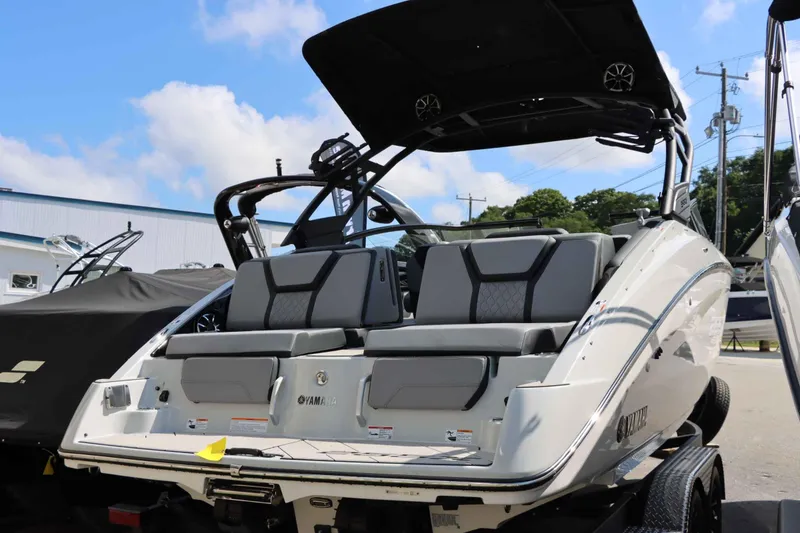 Slide: The Image of 2024 Yamaha Boats 255XE, sleek design, luxury seating, outdoor display. - 15