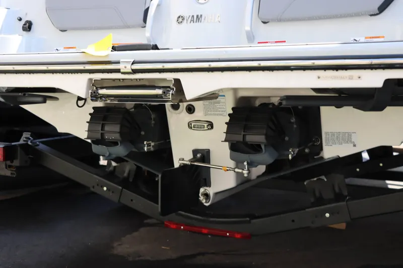 Slide: The Image of 2024 Yamaha Boats 255XE rear view showing dual engines and trailer. - 16